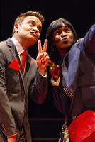 A man and woman dressed in formal suits, standing together with confident expressions.